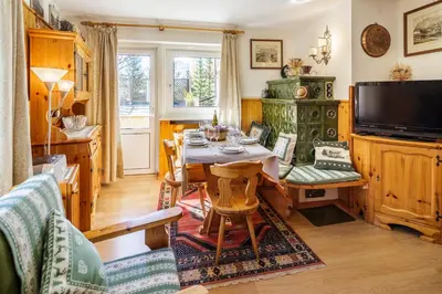 a dining room with a table and a television at CiasaToa in Cortina dʼAmpezzo