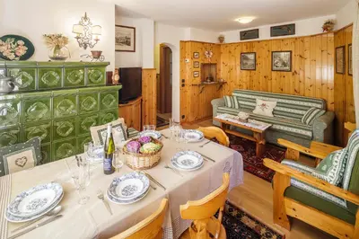 a living room with a table and a couch at CiasaToa in Cortina dʼAmpezzo
