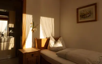 a bedroom with a bed with a pillow and a window at Hotel Roduna in Rodengo