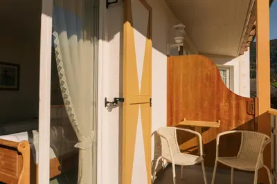 a room with two chairs and a table on a balcony at Hotel Roduna in Rodengo