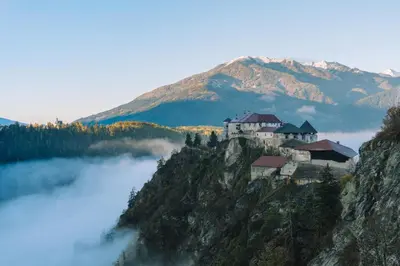 a castle on top of a mountain in the clouds at Hotel Roduna in Rodengo