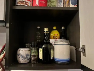 a shelf with bottles and other items on it at Casa Vacanze Carano - El Me Tabià in Carano