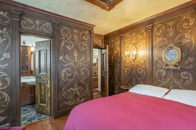 a bedroom with ornate wood paneling and a bed at Apartment Tiarè by My Villa Collection in Cortina dʼAmpezzo