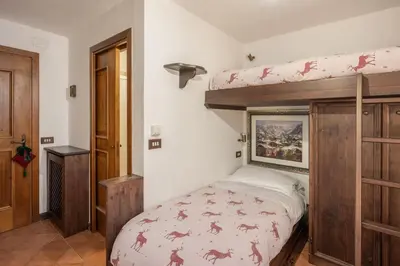 a bedroom with a bunk bed in a room at Apartment Tiarè by My Villa Collection in Cortina dʼAmpezzo