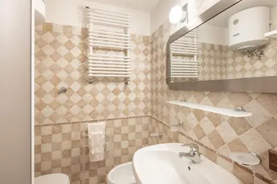 a bathroom with a sink and a mirror at Apartment Tiarè by My Villa Collection in Cortina dʼAmpezzo