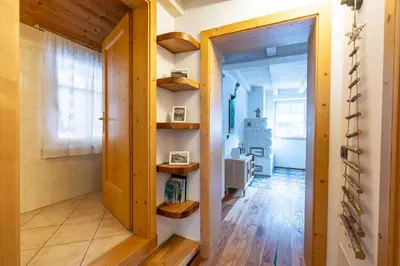 a hallway with a door and shelves in a room at Cesa Cres in Pera
