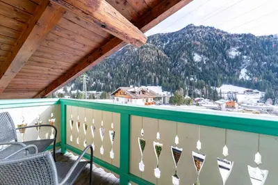 a balcony with chairs and a view of a mountain at Cesa Cres in Pera