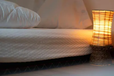 a close up of a bed with a lamp on it at Cesa Cres in Pera