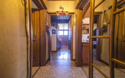 a hallway leading to a kitchen with a hallwayngth at La tua mansada in montagna - Comfort e vista in Cortina dʼAmpezzo
