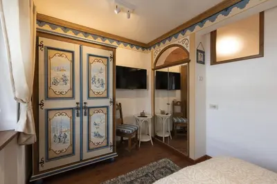 a bedroom with a large blue and white cabinet at Casa Col 2, near ski slopes in Cortina d Ampezzo in Cortina dʼAmpezzo