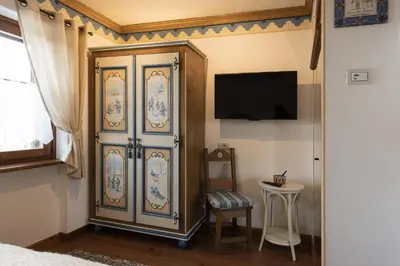 a bedroom with a large blue and white cabinet at Casa Col 2, near ski slopes in Cortina d Ampezzo in Cortina dʼAmpezzo