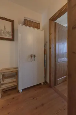 a room with a white cabinet and a door at Casa Col 2, near ski slopes in Cortina d Ampezzo in Cortina dʼAmpezzo