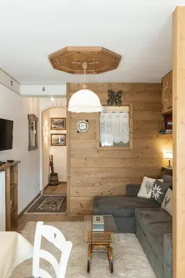 a living room with a couch and a table at Casa Col 2, near ski slopes in Cortina d Ampezzo in Cortina dʼAmpezzo