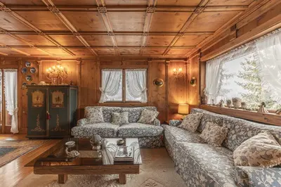 a living room with a couch and a table at Casa La Marignana, ricca di comfort a Cortina d Ampezzo in Cortina dʼAmpezzo