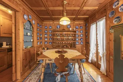 a dining room with a table and plates on the wall at Casa La Marignana, ricca di comfort a Cortina d Ampezzo in Cortina dʼAmpezzo