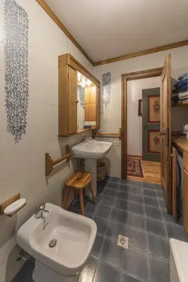 a bathroom with a toilet and a sink at Casa La Marignana, ricca di comfort a Cortina d Ampezzo in Cortina dʼAmpezzo