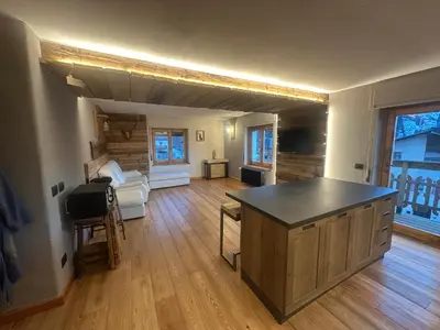 a large living room with a large island in the middle at Appartamento PELMO in Selva di Cadore