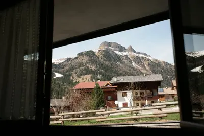 a view of a mountain from a train window at Appartamento Doleda in Canazei