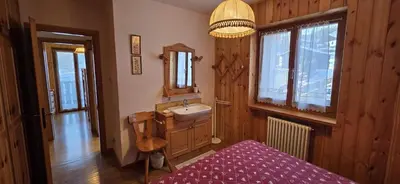 a bathroom with a sink and a mirror at Casa Vaiolet in Pozza di Fassa