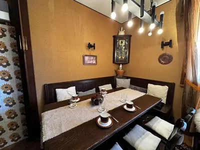a dining room with a wooden table and chairs at Cortina Chalet Skyview in Zuel