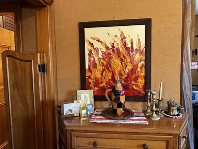 a wooden dresser with a painting on the wall at Cortina Chalet Skyview in Zuel
