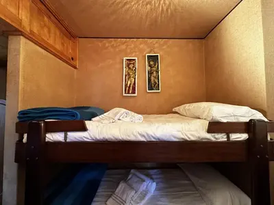 a bed in a room with two pictures on the wall at Cortina Chalet Skyview in Zuel