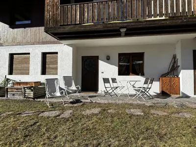 a group of chairs sitting outside of a house at Cortina Chalet Skyview in Zuel