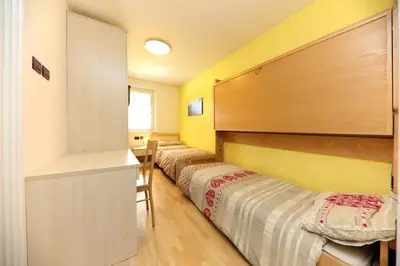 a kitchen with a sink and a table in a room at Villa Marta in Mazzin