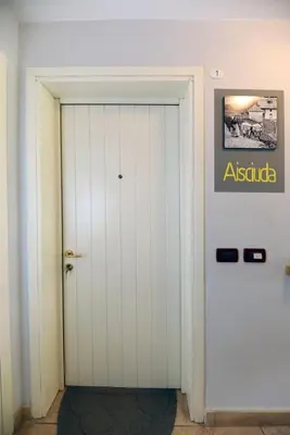 a building in the snow with mountains in the background at Villa Marta in Mazzin