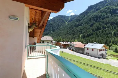 a balcony with a view of a town and mountains at Villa Marta in Mazzin