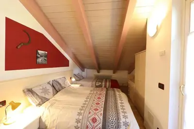 a small bedroom with a bed in a attic at Villa Marta in Mazzin
