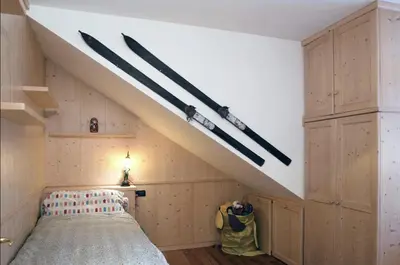a attic bedroom with a bed and a skylight at Maso Gretel in Tesero