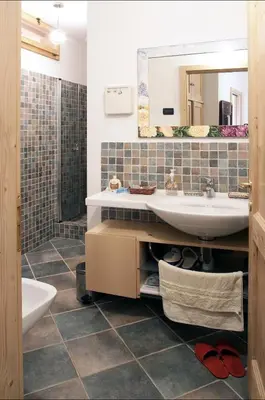 a bathroom with a sink and a mirror at Maso Gretel in Tesero
