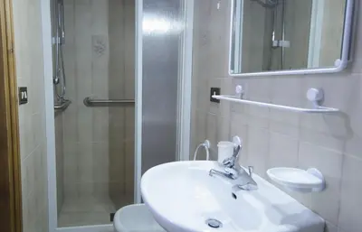 a bathroom with a sink and a shower at Nel cuore di Cortina comodo appartamento con parcheggio in Cortina dʼAmpezzo