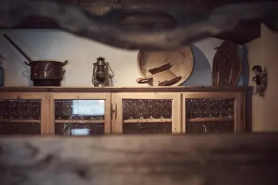 a wooden cabinet with various items on top of it at Apartments Knappenhof Pfitsch - with Swimming Pool in Val di Vizze