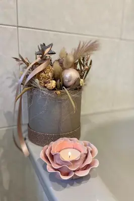 a vase with a candle on a counter next to a plate at Apartment Cesa Vedla DOLOMITES by Interhome in Bulla