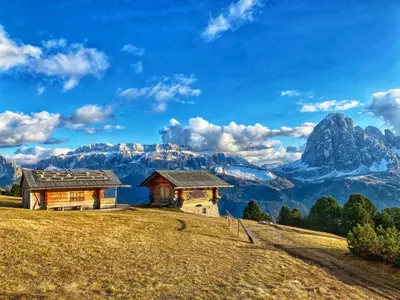 a house on a hill with mountains in the background at Apartment Cesa Vedla DOLOMITES by Interhome in Bulla
