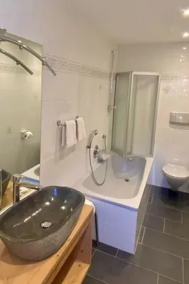 a bathroom with a large sink and a toilet at Apartment Cesa Vedla DOLOMITES by Interhome in Bulla