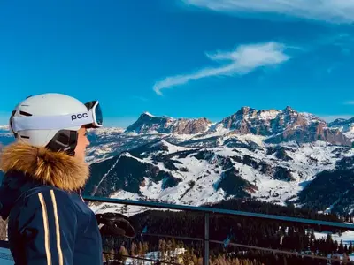 a person is looking at the snow covered mountains at Apartment Cesa Vedla DOLOMITES by Interhome in Bulla