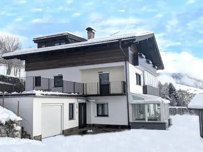 a white house with snow on the ground at Apartment Morgensonne by Interhome in Maranza