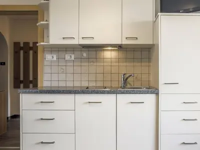 a kitchen with white cabinets and a sink at Apartment Morgensonne by Interhome in Maranza