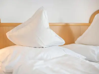 two white pillows sitting on top of a bed at Apartment App- Haselstaude by Interhome in Maranza