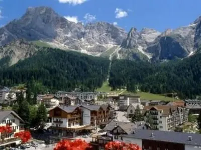 a view of a town with mountains in the background at Holiday Home Romantisches Chalet in den Wiesen der Dolomiten by Interhome in Mezzano