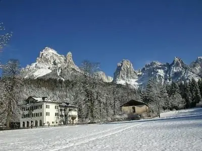 a building in the middle of a snow covered mountain at Holiday Home Romantisches Chalet in den Wiesen der Dolomiten by Interhome in Mezzano