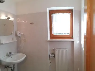 a small bathroom with a sink and a window at Apartment Wohnung Valentin by Interhome in Meltina