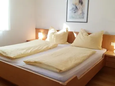 a bedroom with two beds with white sheets and pillows at Apartment Wohnung Valentin by Interhome in Meltina