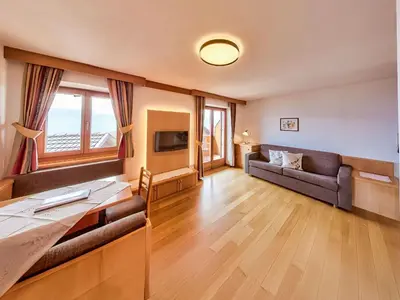 a living room with a couch and a television at Apartment Wohnung Mölten by Interhome in Meltina