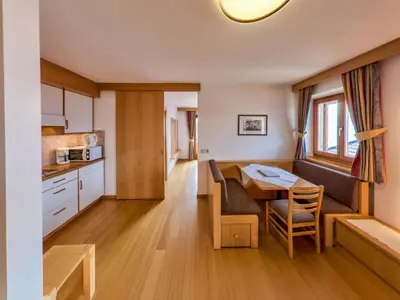 a kitchen and dining room with a table and a dining room at Apartment Wohnung Mölten by Interhome in Meltina