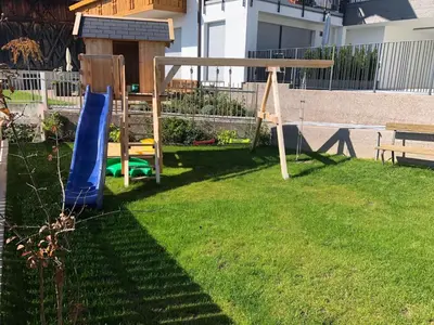 a yard with a swing set and a playground at Apartment Wohnung Mölten by Interhome in Meltina