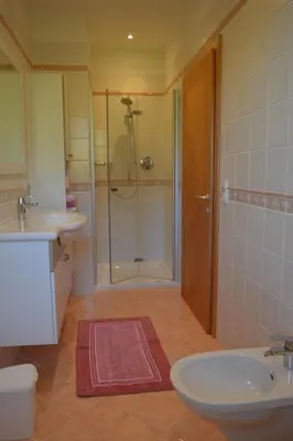 a bathroom with a shower and a sink and a toilet at Apartment Moderne Ferienwohnung mit Balkon und Pool by Interhome in Merano